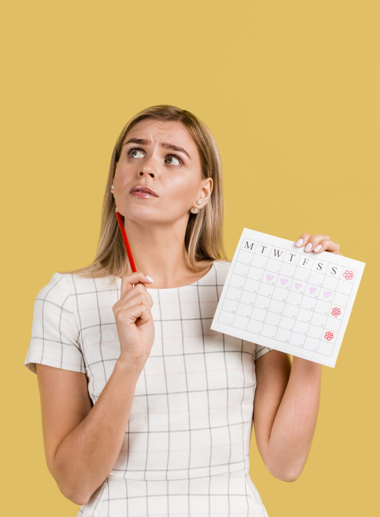 front-view-woman-showing-her-period-calendar-with-copy-space (1)